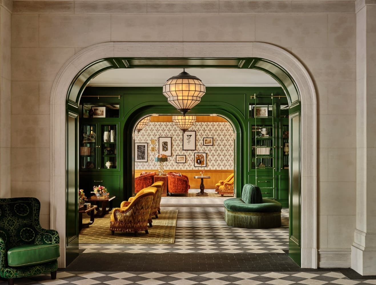 archways with green and gold accents leading to a lobby sitting area