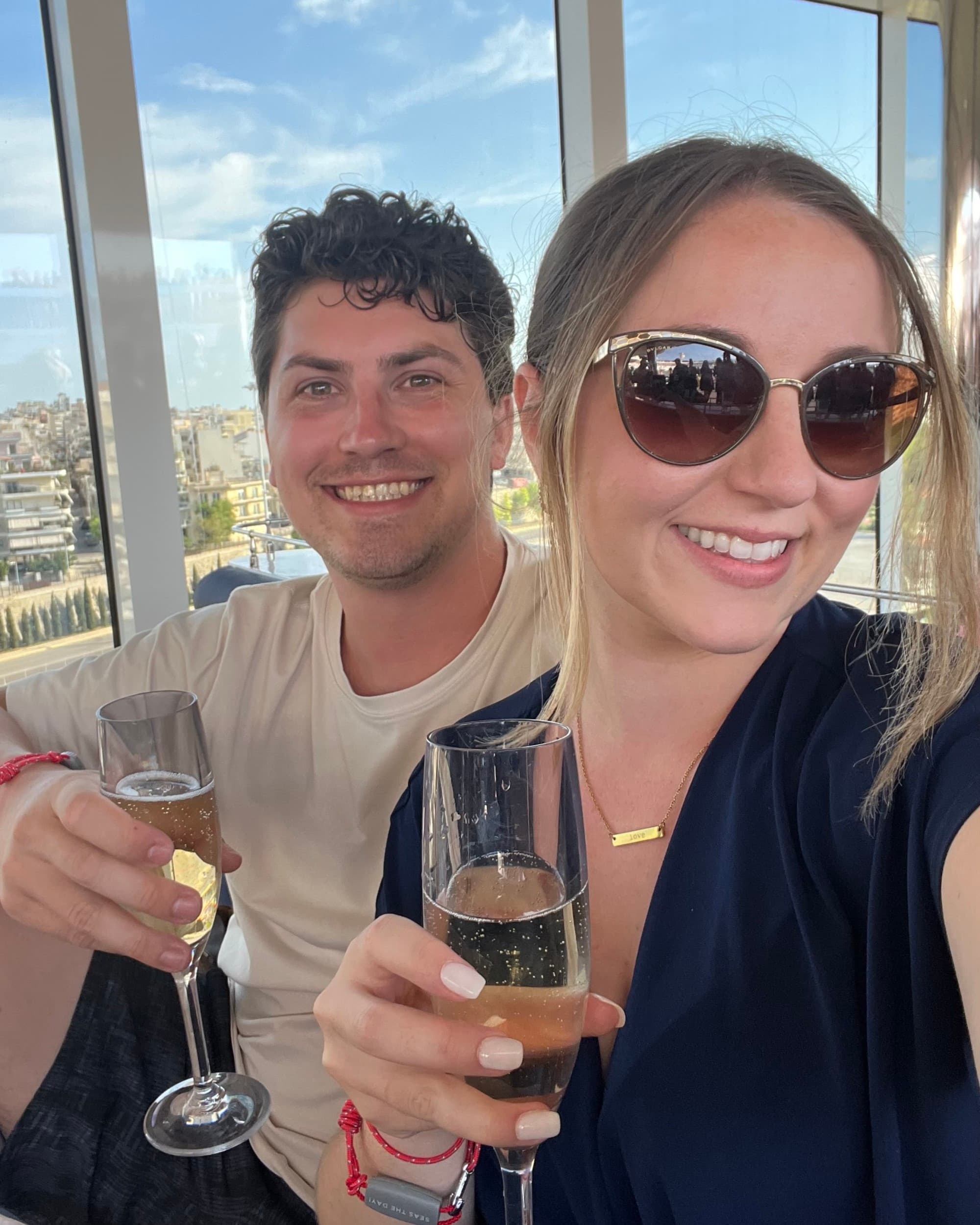 Selfie of a couple holding flutes of champagne.