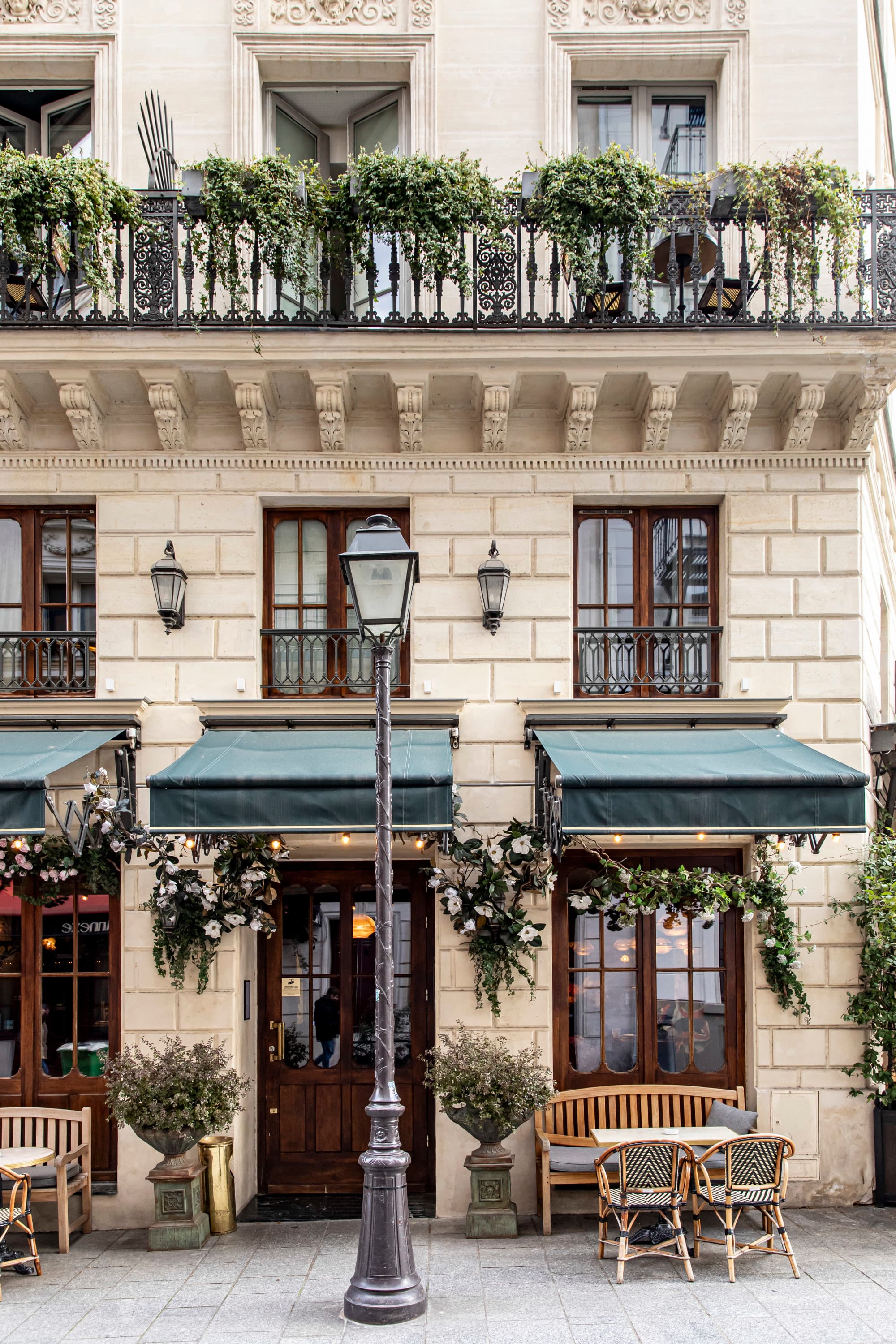 a lamp post outside of an elegant building in Paris