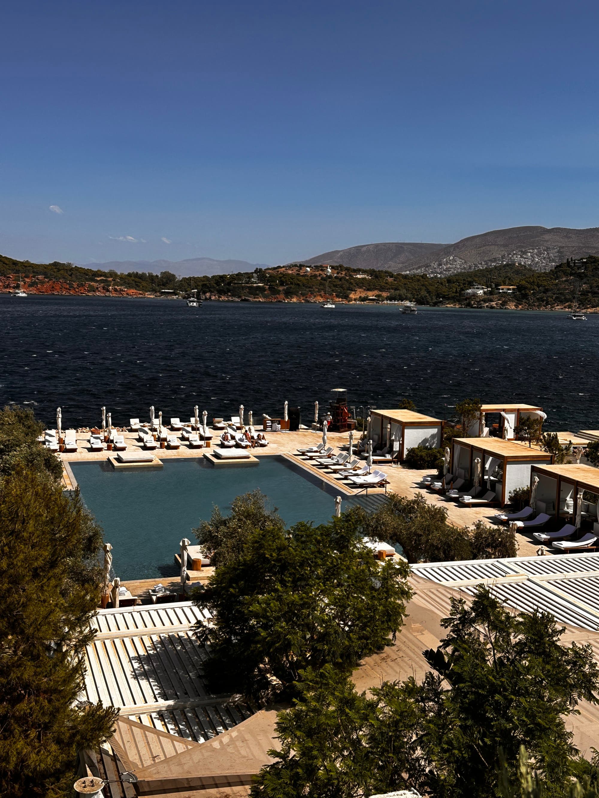Pool view from balcony at the seaside hotel, Athens on a sunny day.