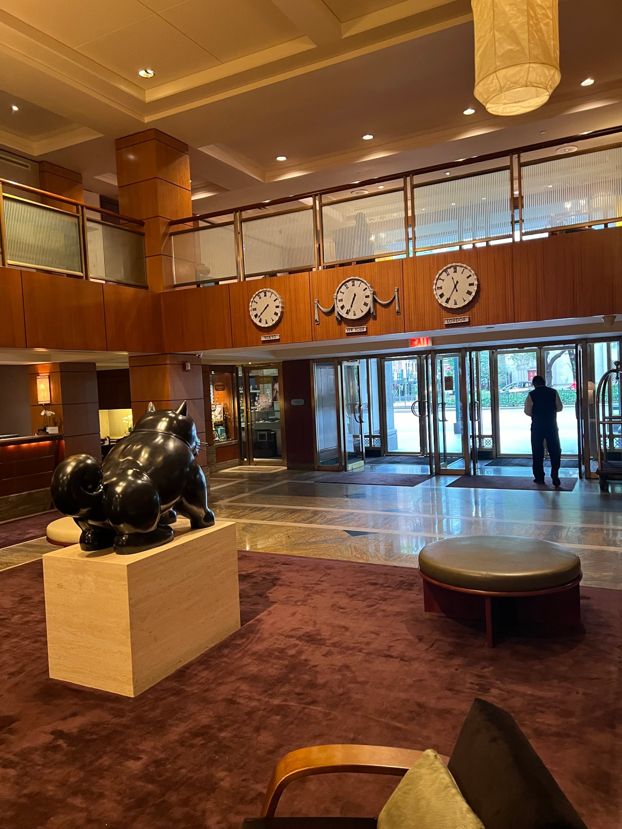 Hotel interior with light fixtures and rotating doors.