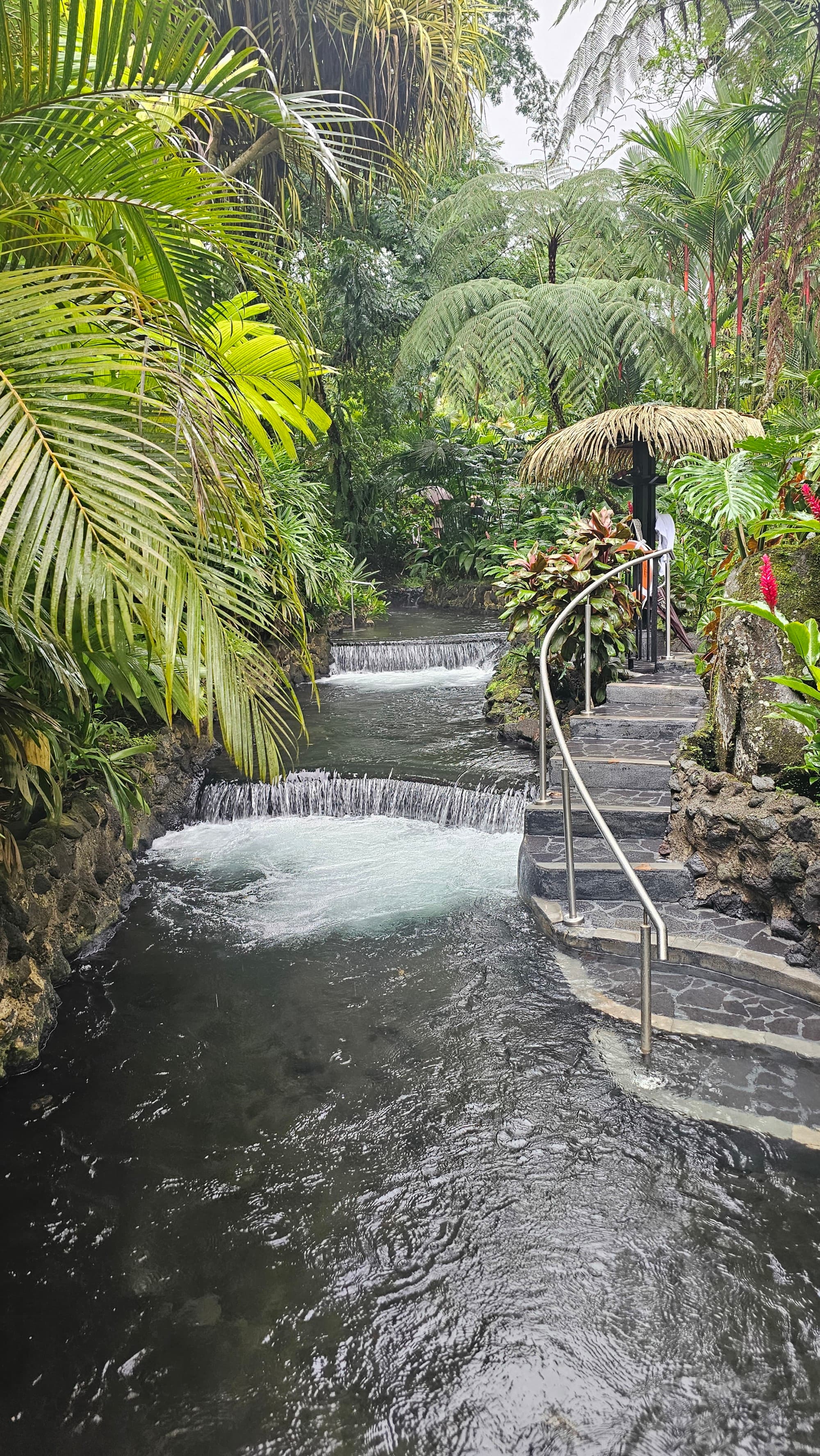 A hot springs plunging area with steps and small tiered waterfalls