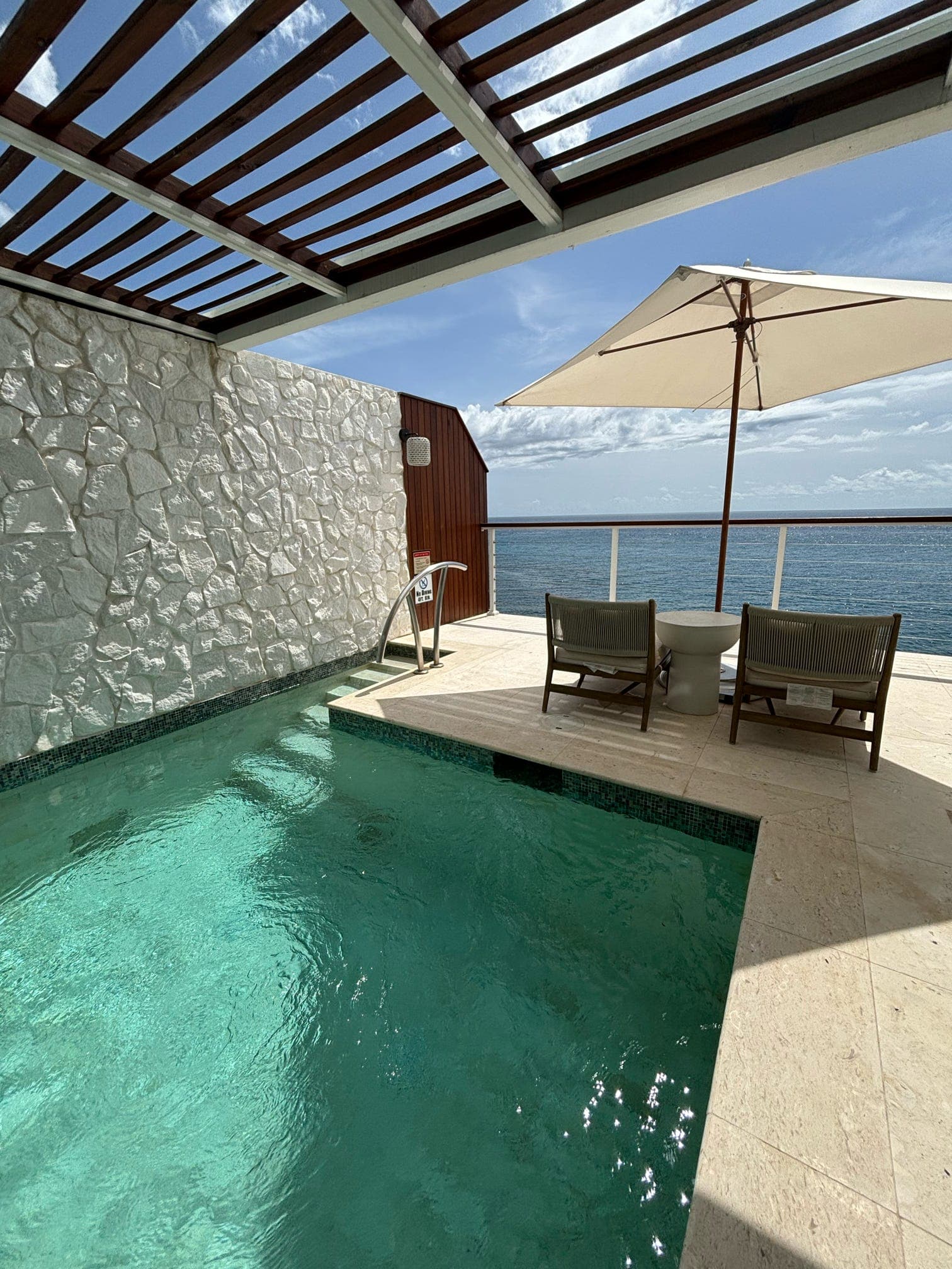 An outdoor swimming pool area the daytime