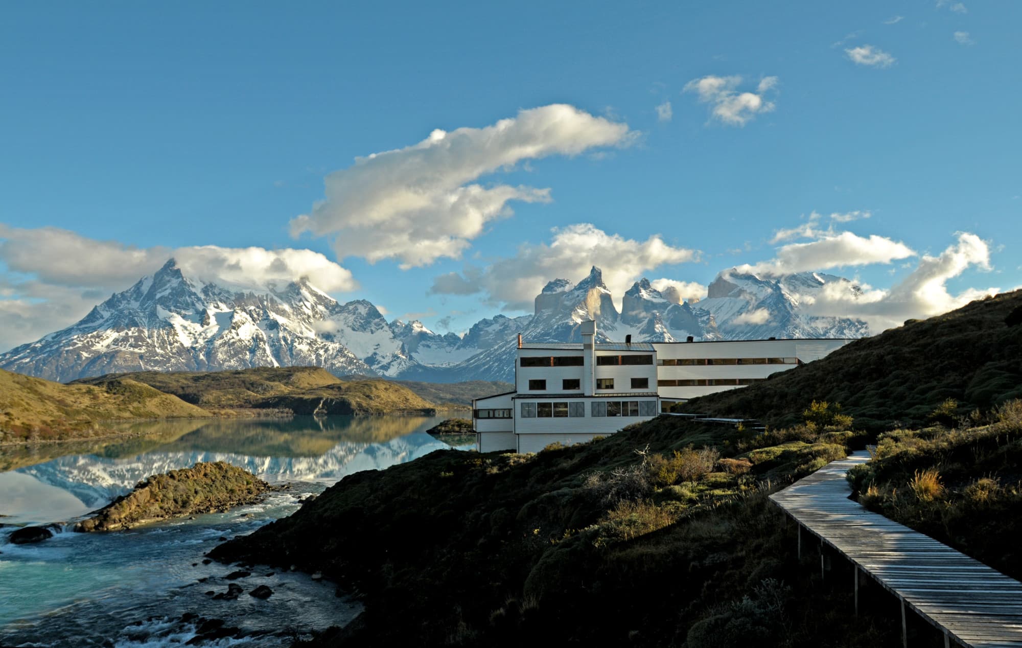 dramatic mountain peaks and blue sky with a white building