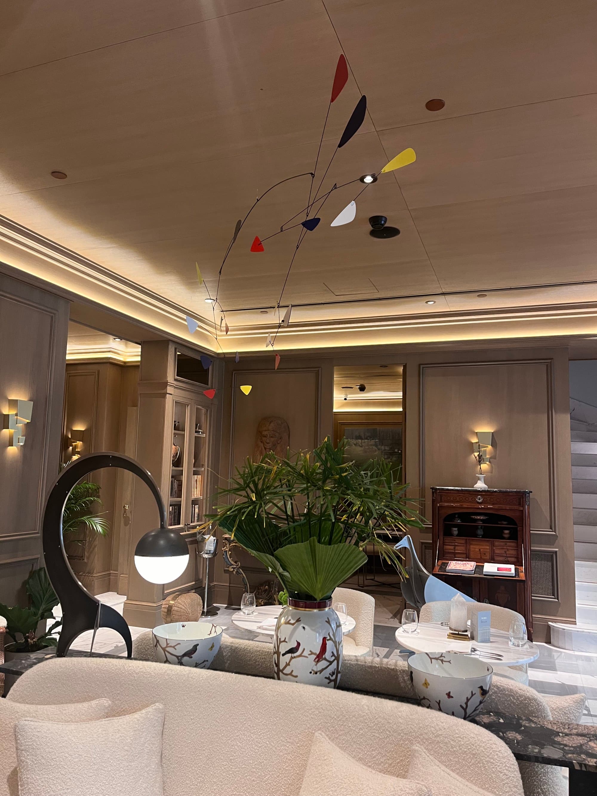 The hotel interior features modern amenities and comfortable chairs.