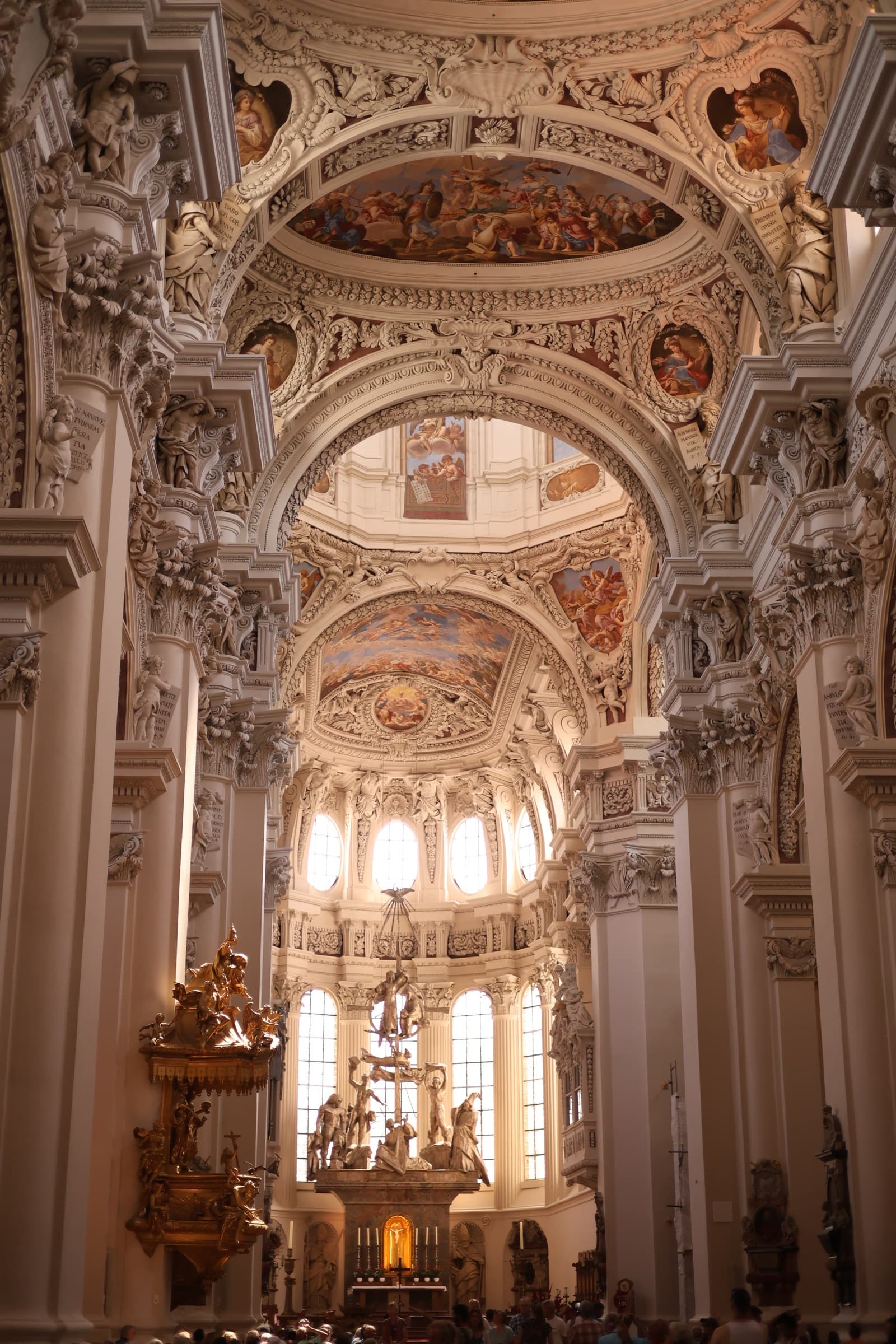 The inside of a castle with tall, painted ceilings