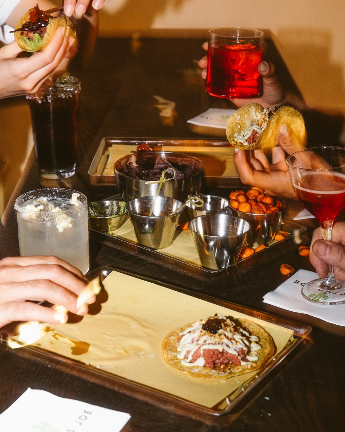 close-up of people eating tapas at a cool bar