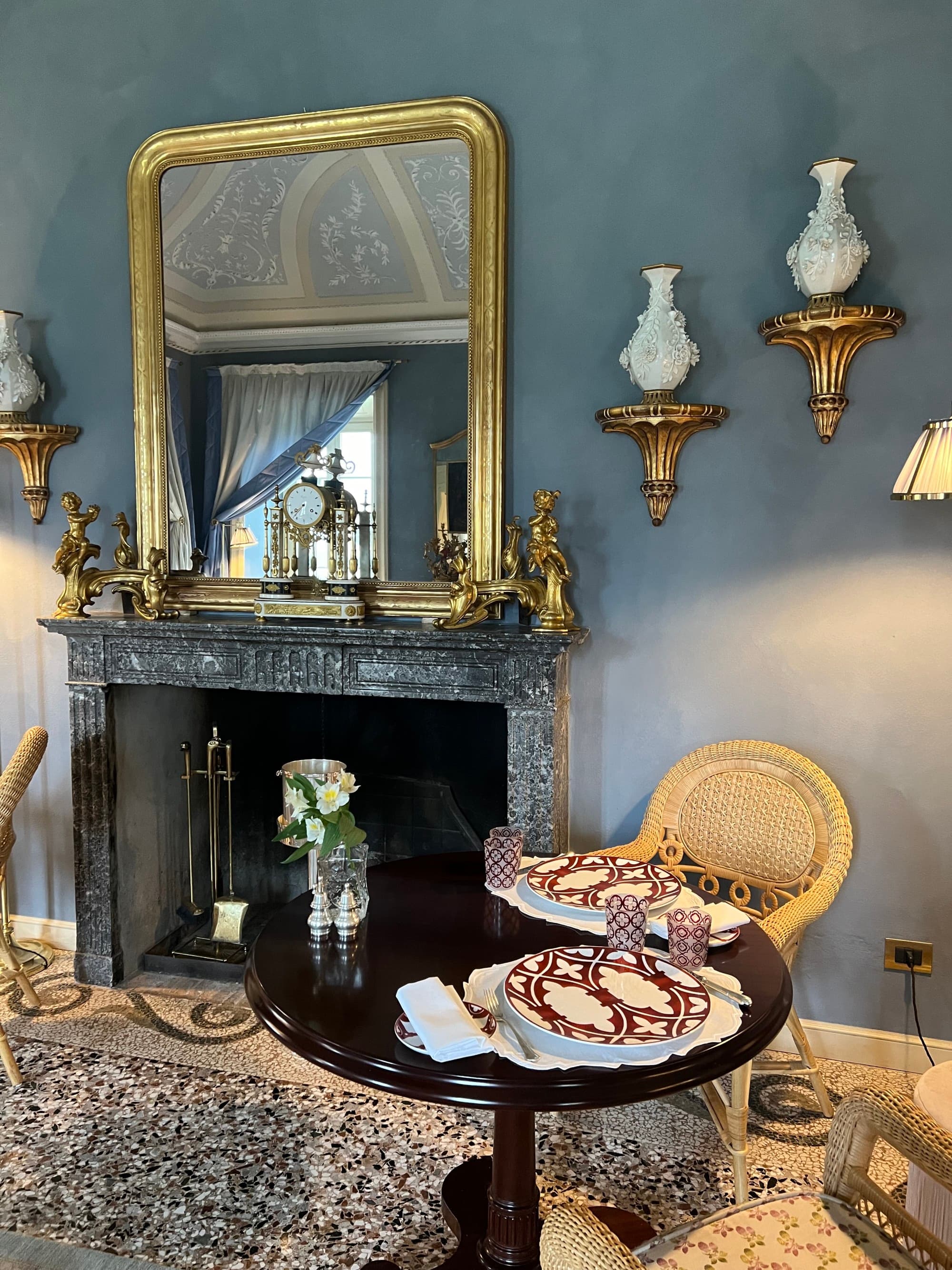 The hotel interior boats golden accents and cozy, antique touches throughout the rooms.