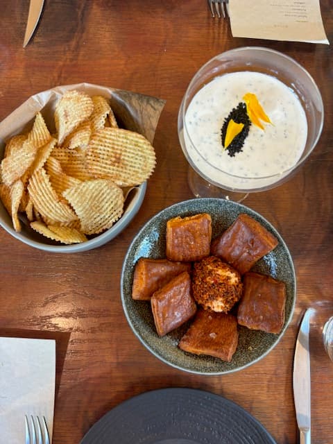 An array of small bites in dishes on a table.