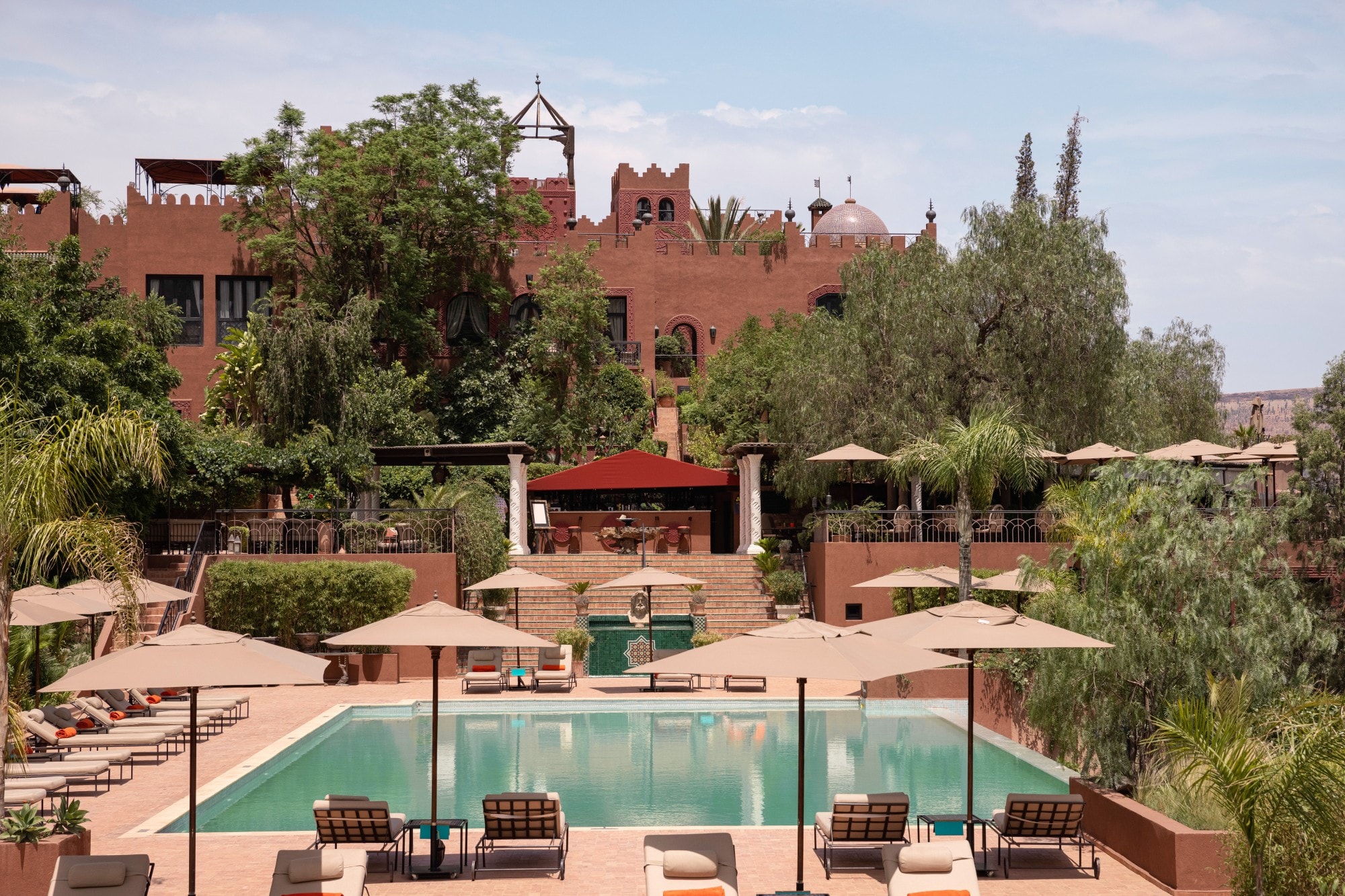 aerial view of a hotel pool in a luxe Moroccan courtyard