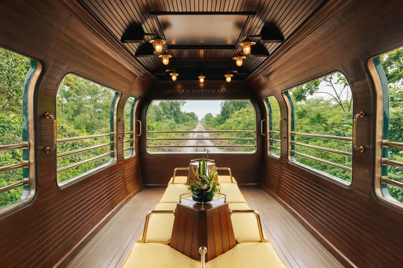 a wooden train cabin with yellow banquettes