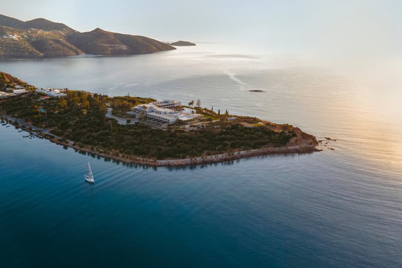 A view from above of an inlet in the ocean with Minos Palace Hotel.