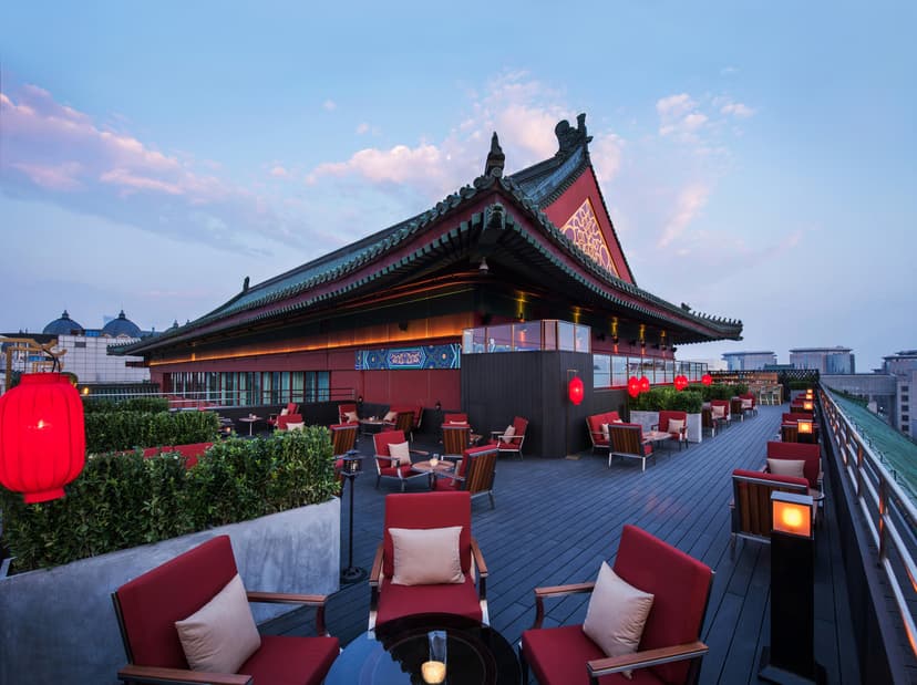 red tables and chairs on a rooftop dining pavilion