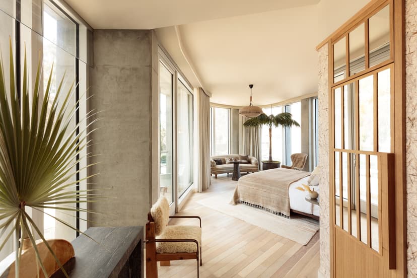 A spacious hotel room with neutral tones and furnishings at the Santa Monica Proper hotel.