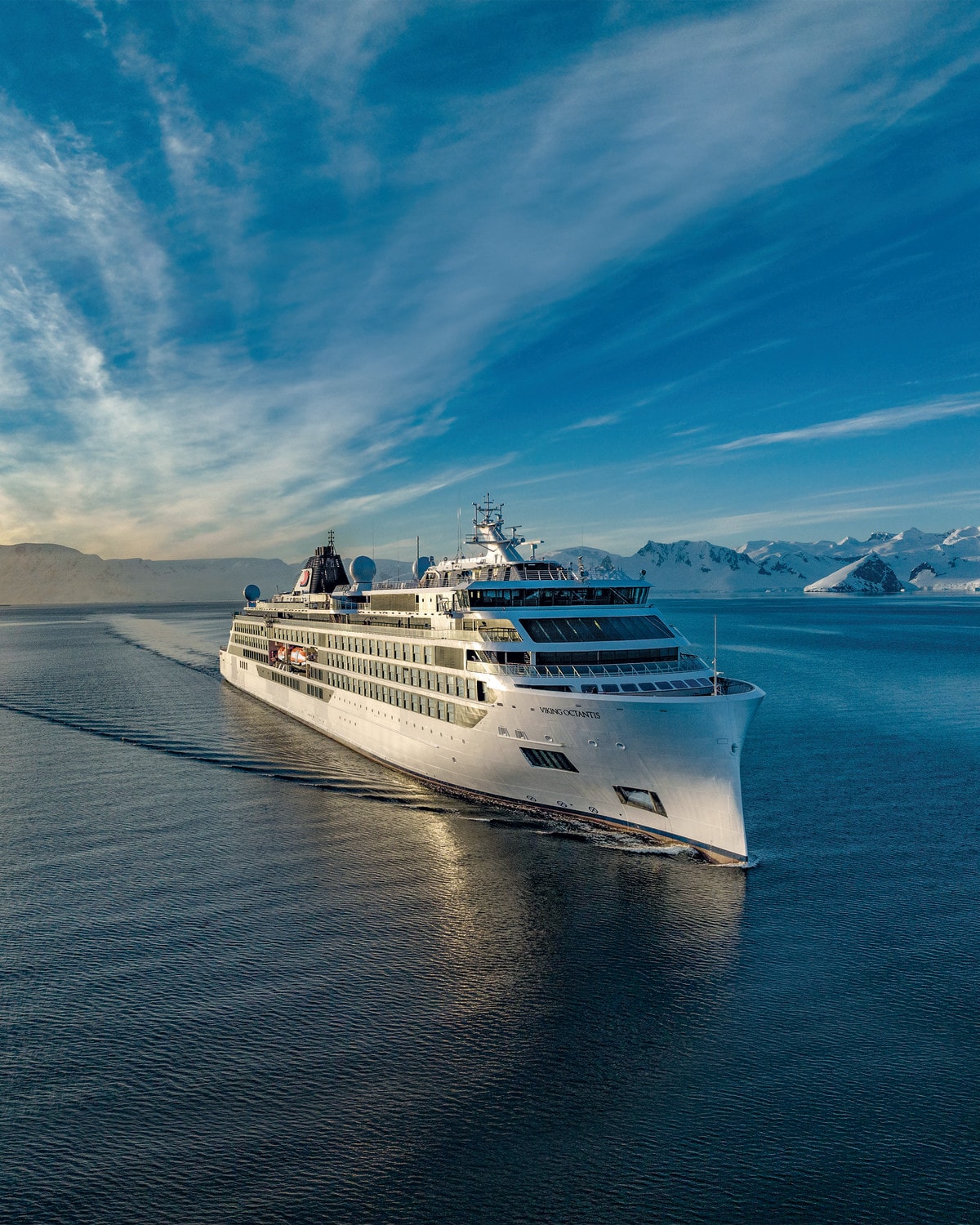 large cruise ship in the ocean near a glacier