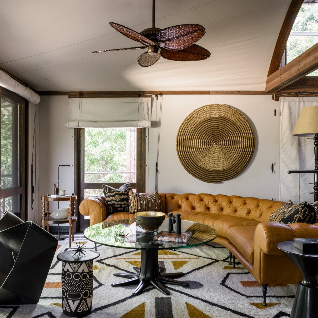 fancy living room with a tan couch and angular furniture