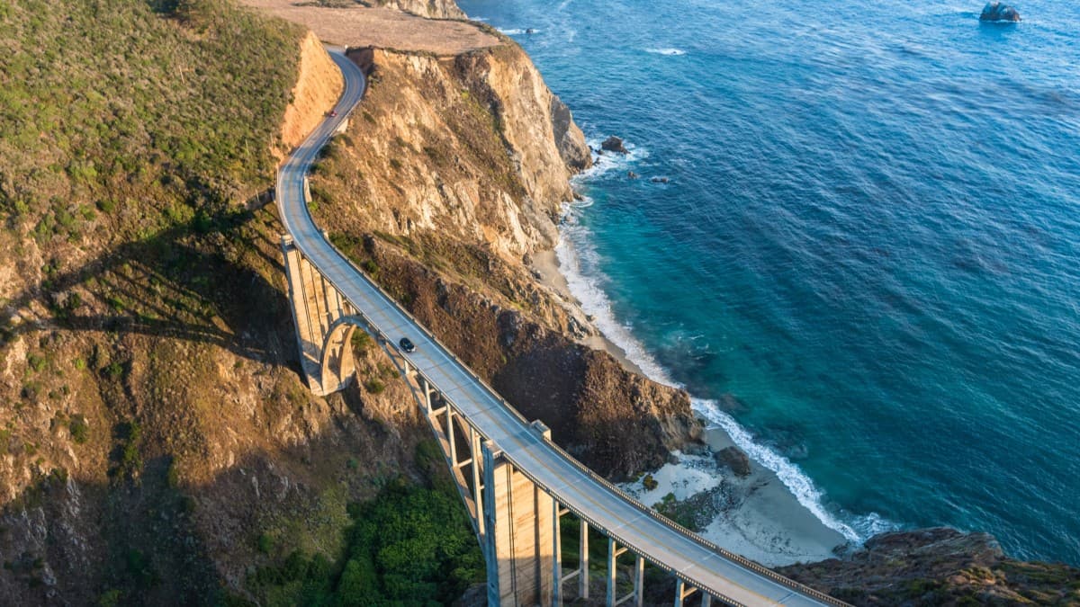 Birdview of Bixby Bridge on PCH highway overlooking the Pacific Ocean and sitting above the Big Sur's oceanside cliffs in Monterey County, CA.