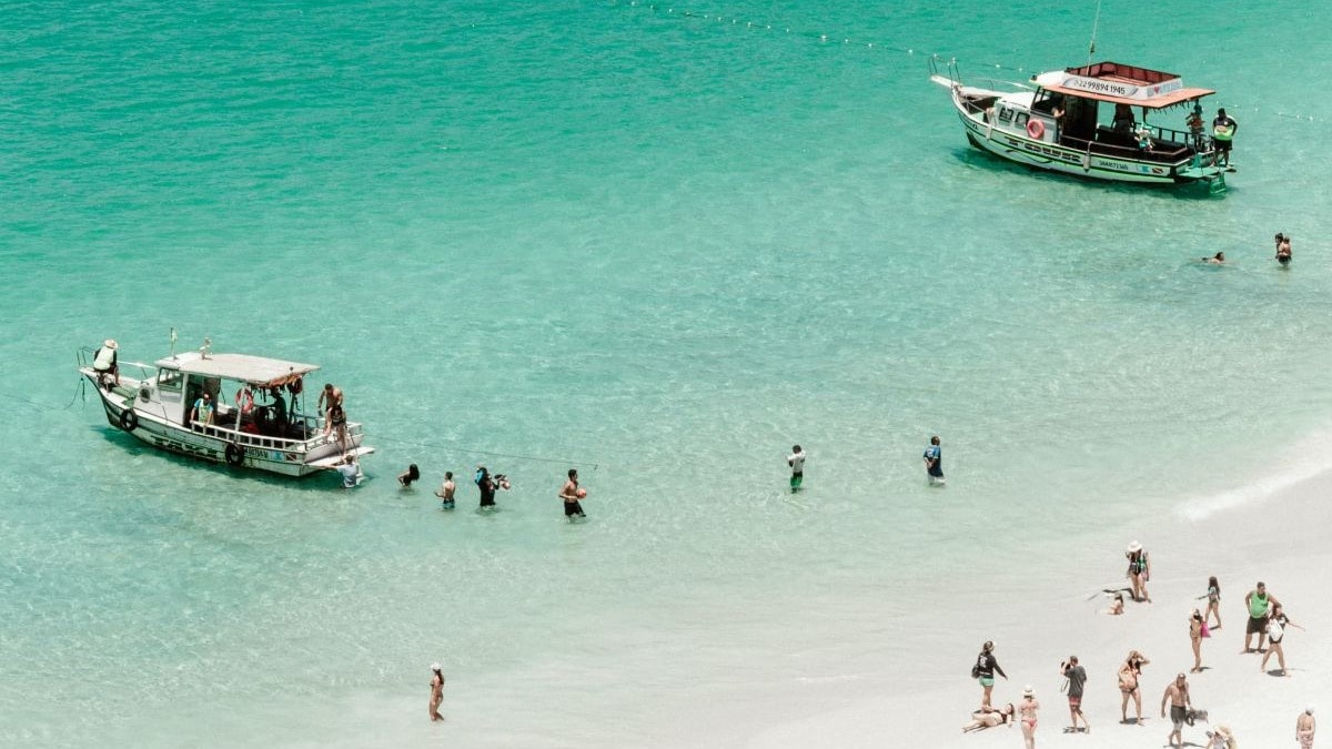 aerial view of a white-sand beach dotted with people