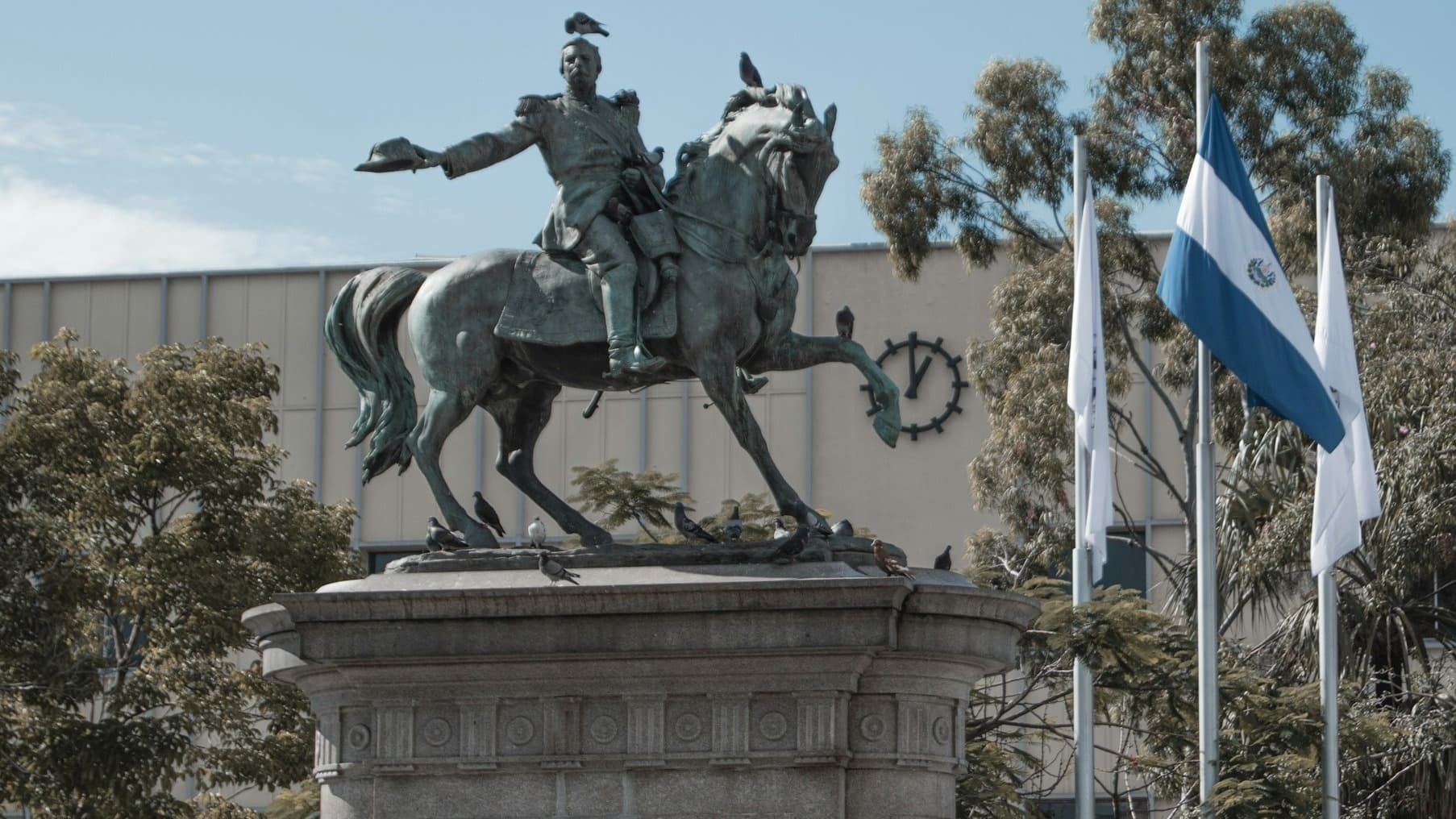 a moon rises over a lake