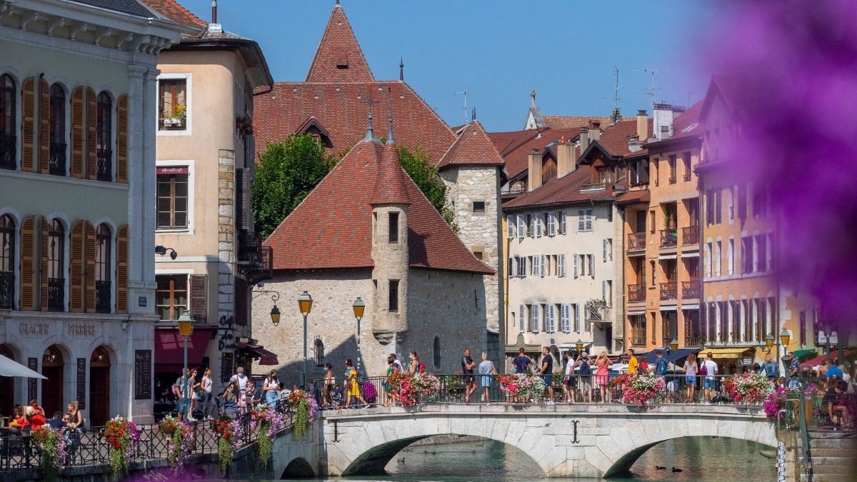People walking on a bridge on a river.