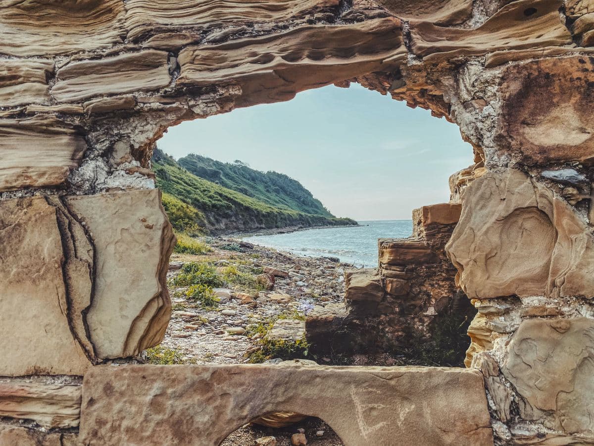 Rock formation near a body of water and cliffsides