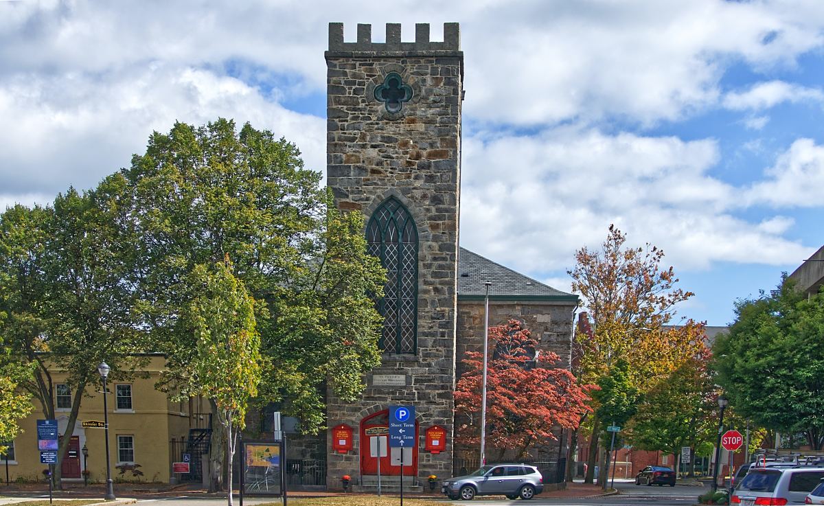 Large brick building surrounded by foliage