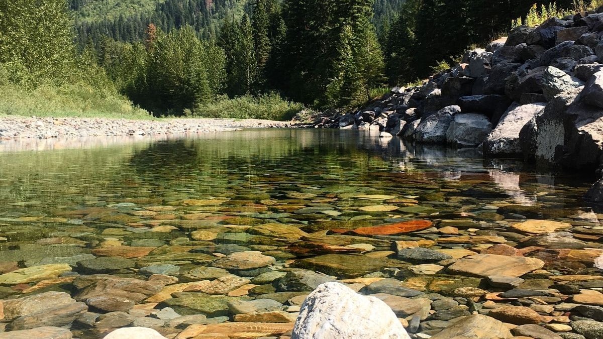 alpine lake in the valley of towering rocky peaks