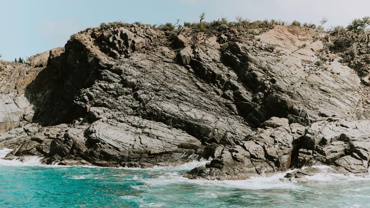 Craggy rock formation in a clear blue sea