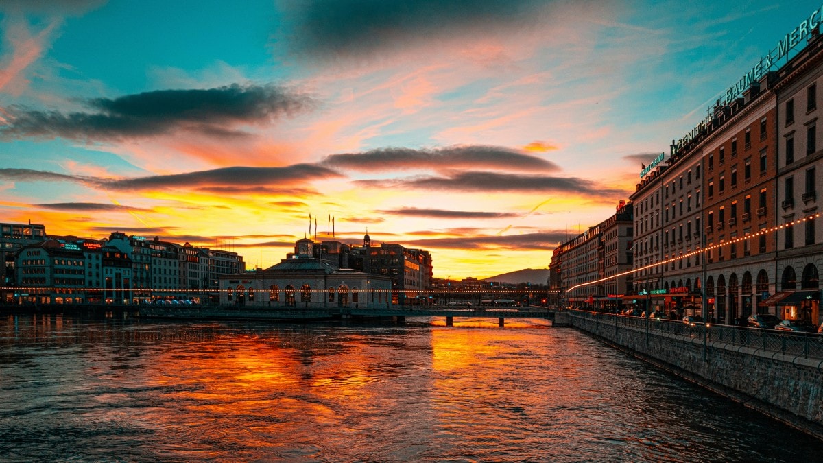 A beautiful view of Geneva with a water way at sunset