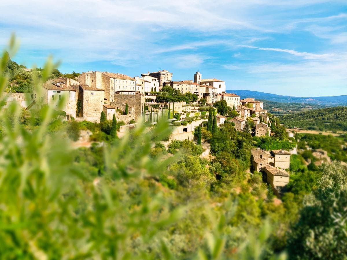 Village on lush hilltop in the South of France on a sunny day.