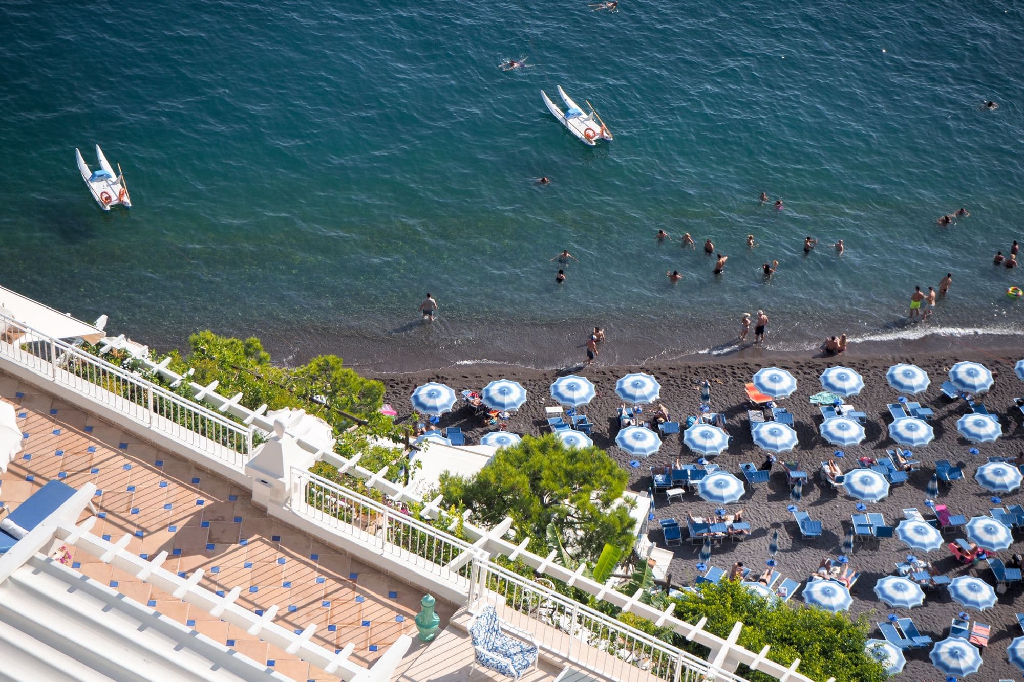 aerial view of blue umbrellas on a beach