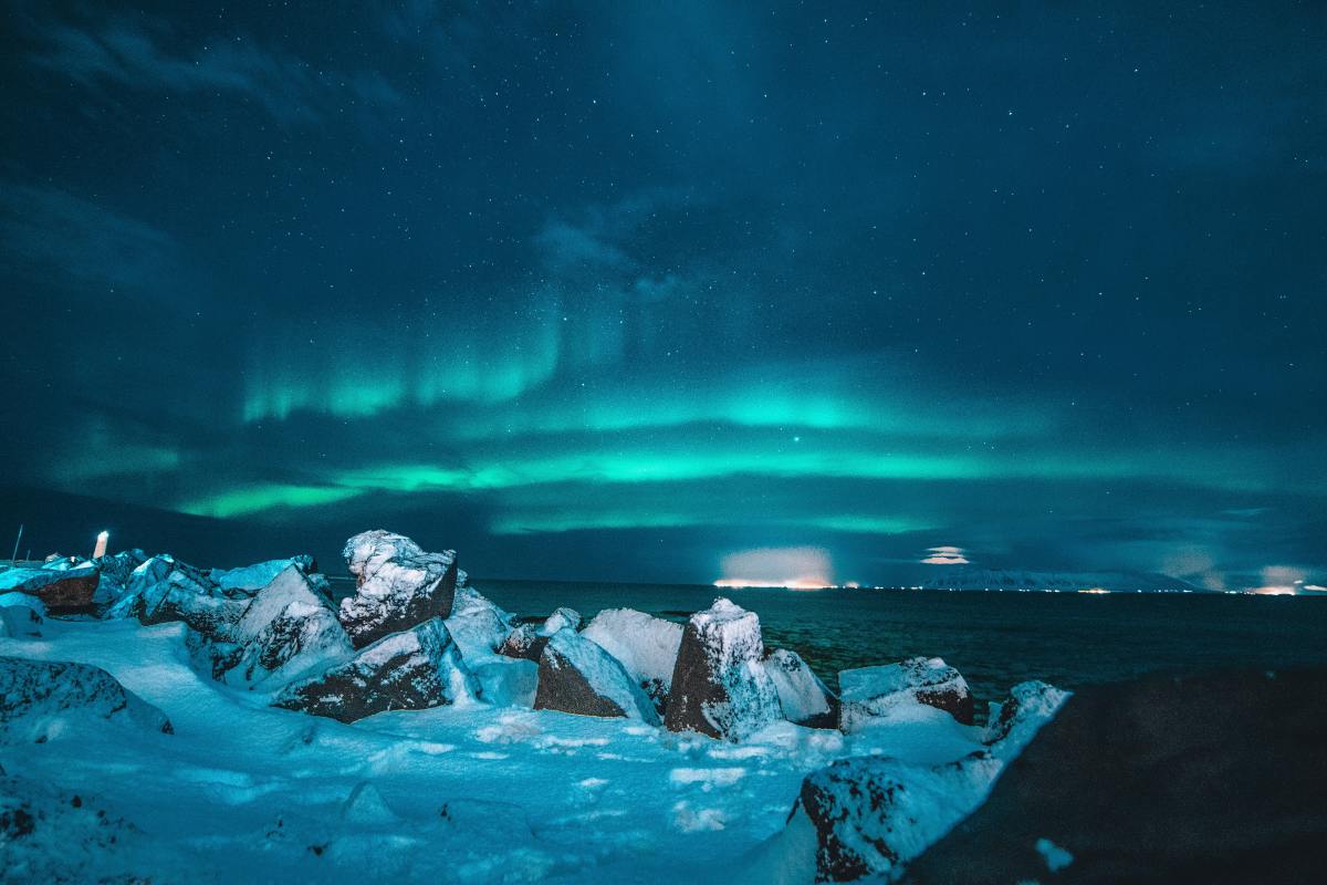 The northern lights shining over a glacier in Iceland
