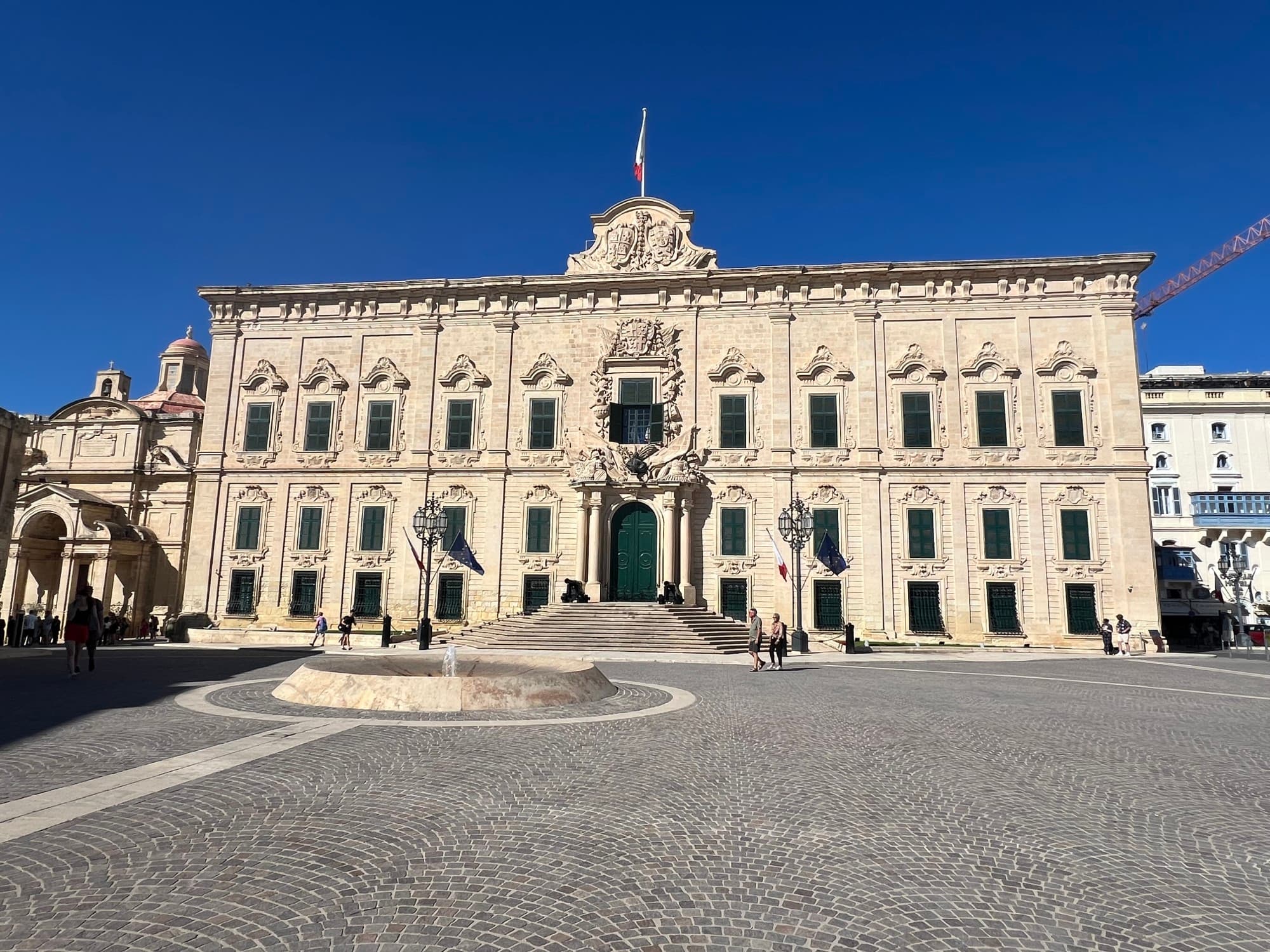 Exterior of a classical building with a clear blue sky overhead.