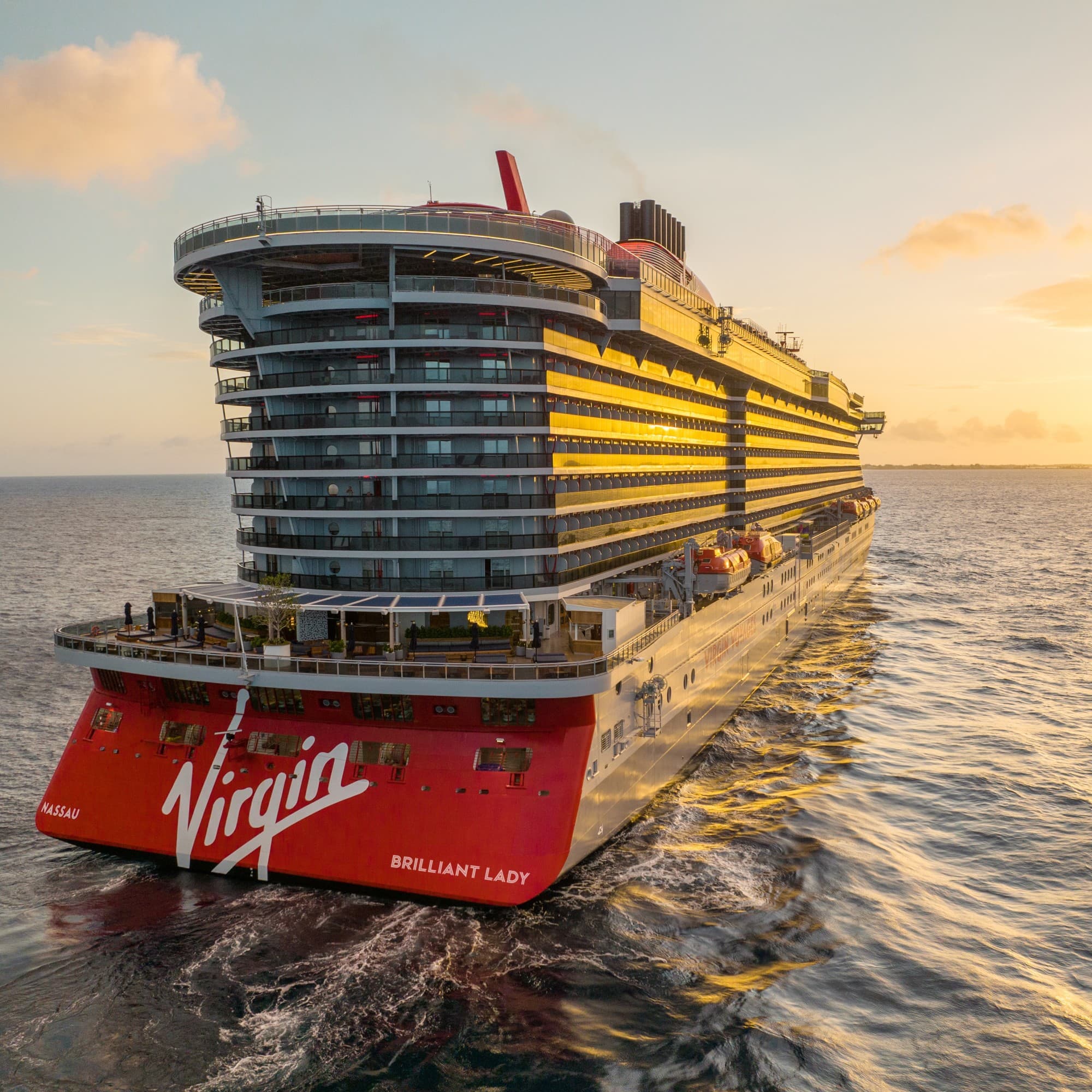 Virgin Brilliant lady cruise on the open sea at sunset.