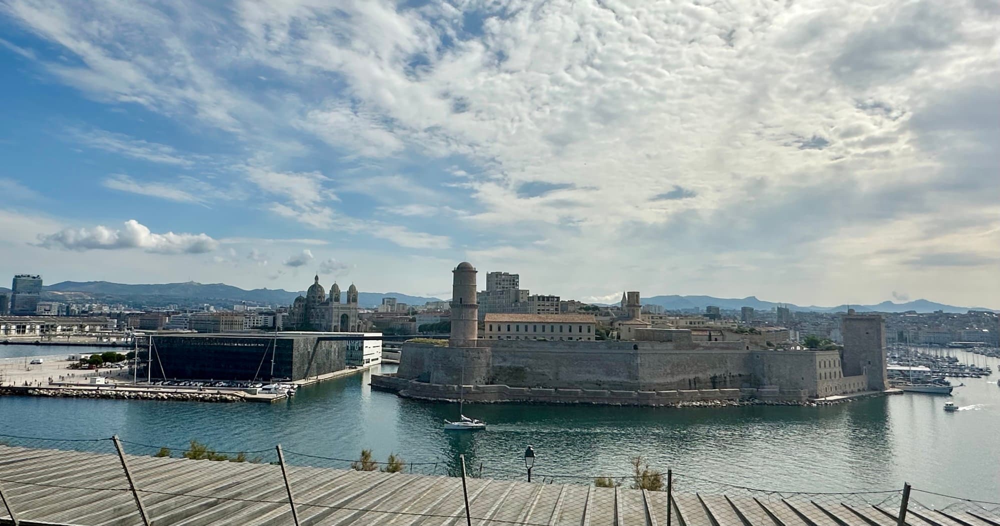 A city with water around it is seen from a distance.
