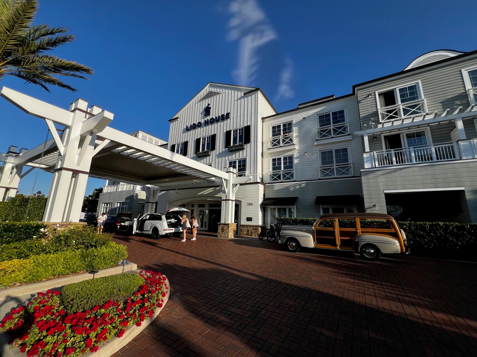The outside of a white hotel building during the daytime