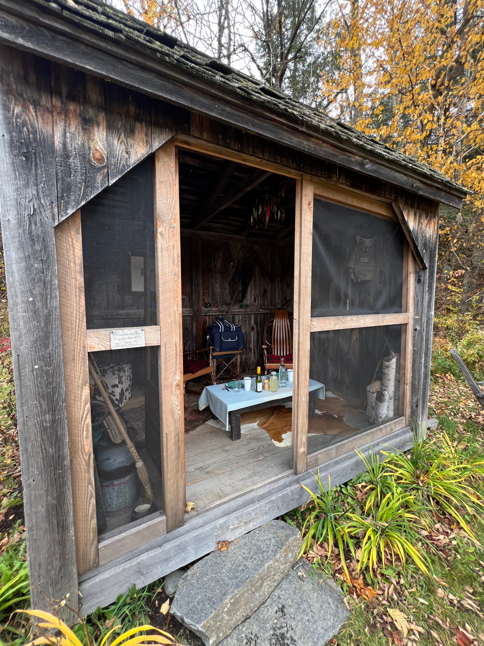 Private picnic set up by the pond during the day time with nature in the distance.