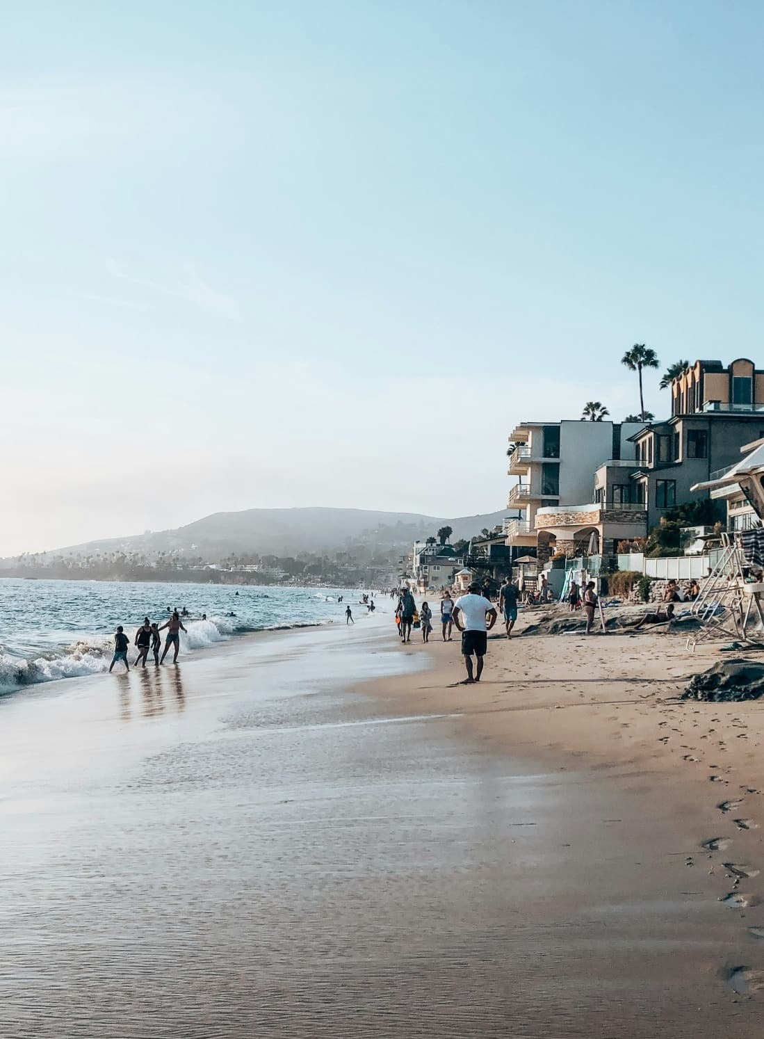 Sea and seaside view with people walking on the beach.