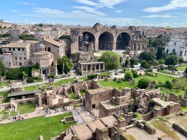 A Sorrento to Rome trip includes seeing these ruins, which are surrounded by grass and trees - Janelle Smith