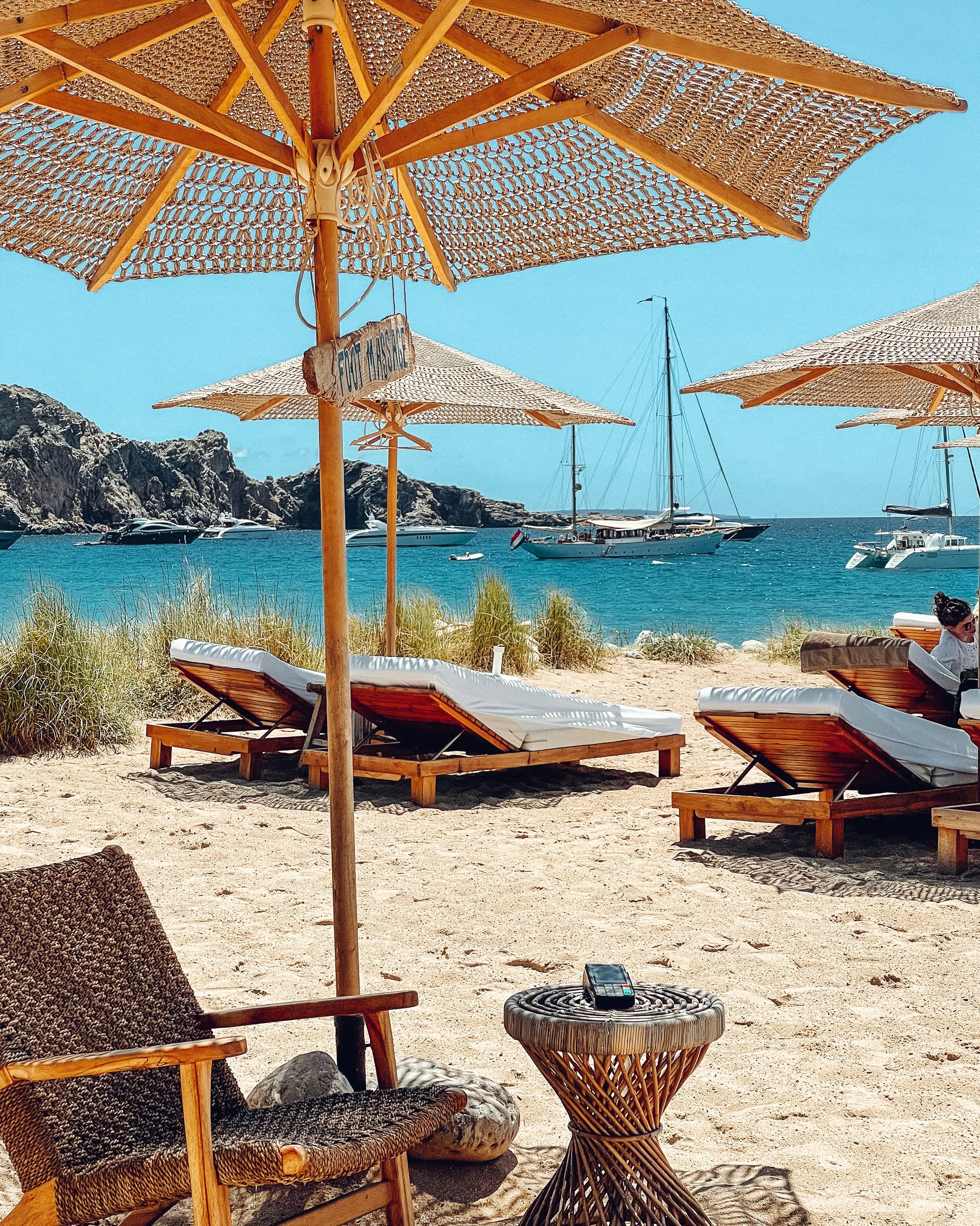 Beach loungers under an umbrella in Ibiza.