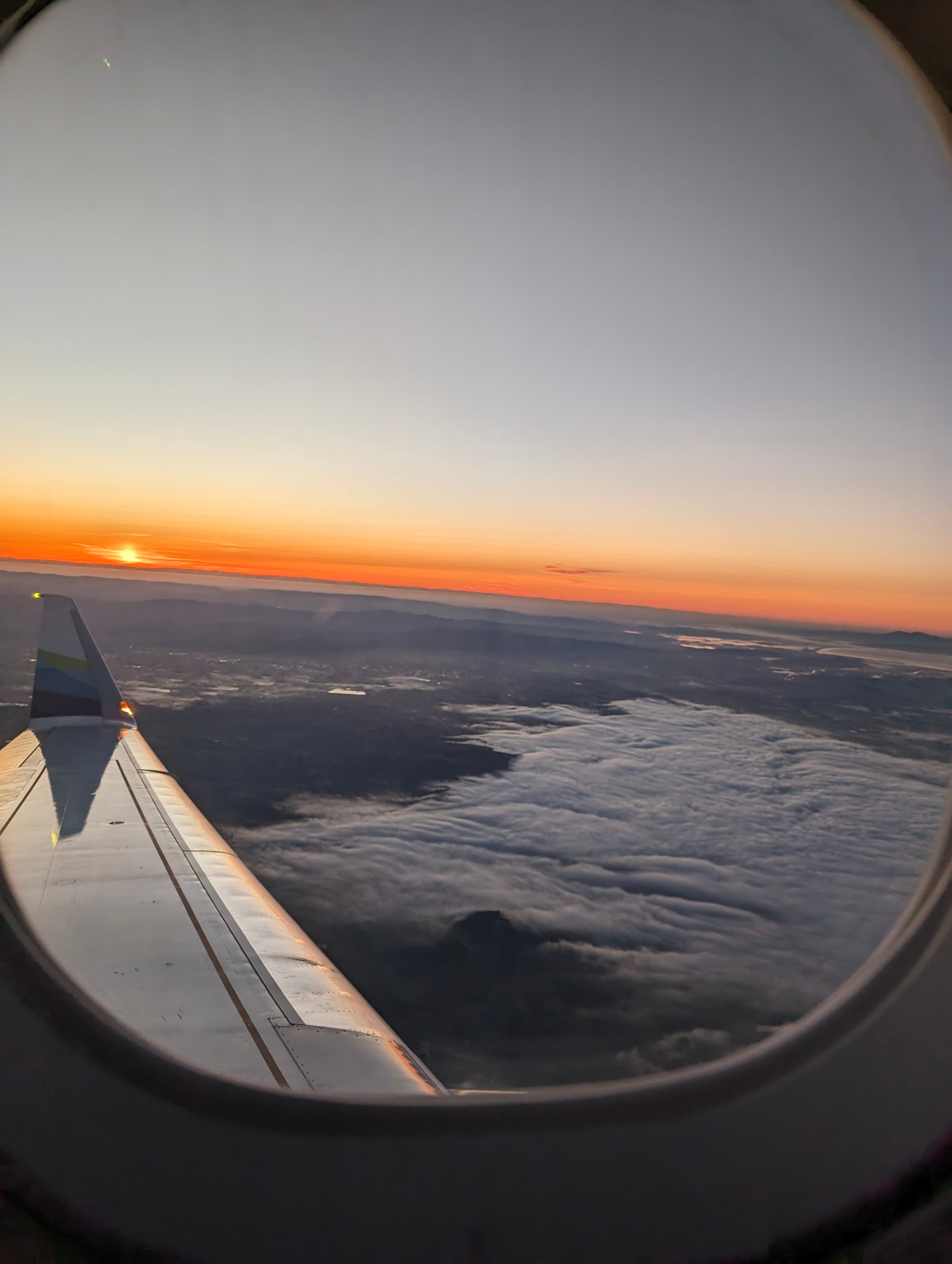 View of a sunset from the window of a plane