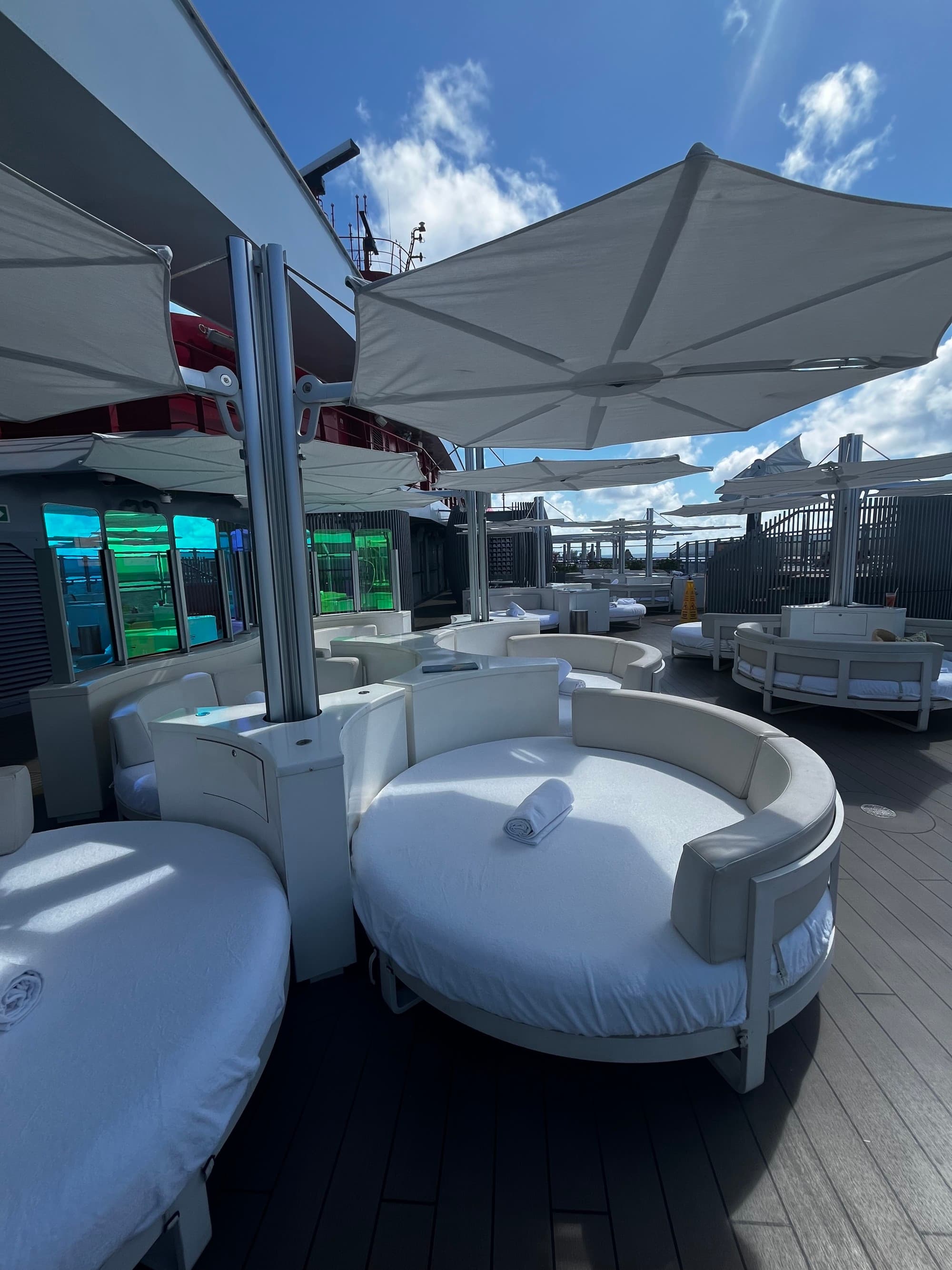 A patio seating area with large, white, round chairs during the daytime