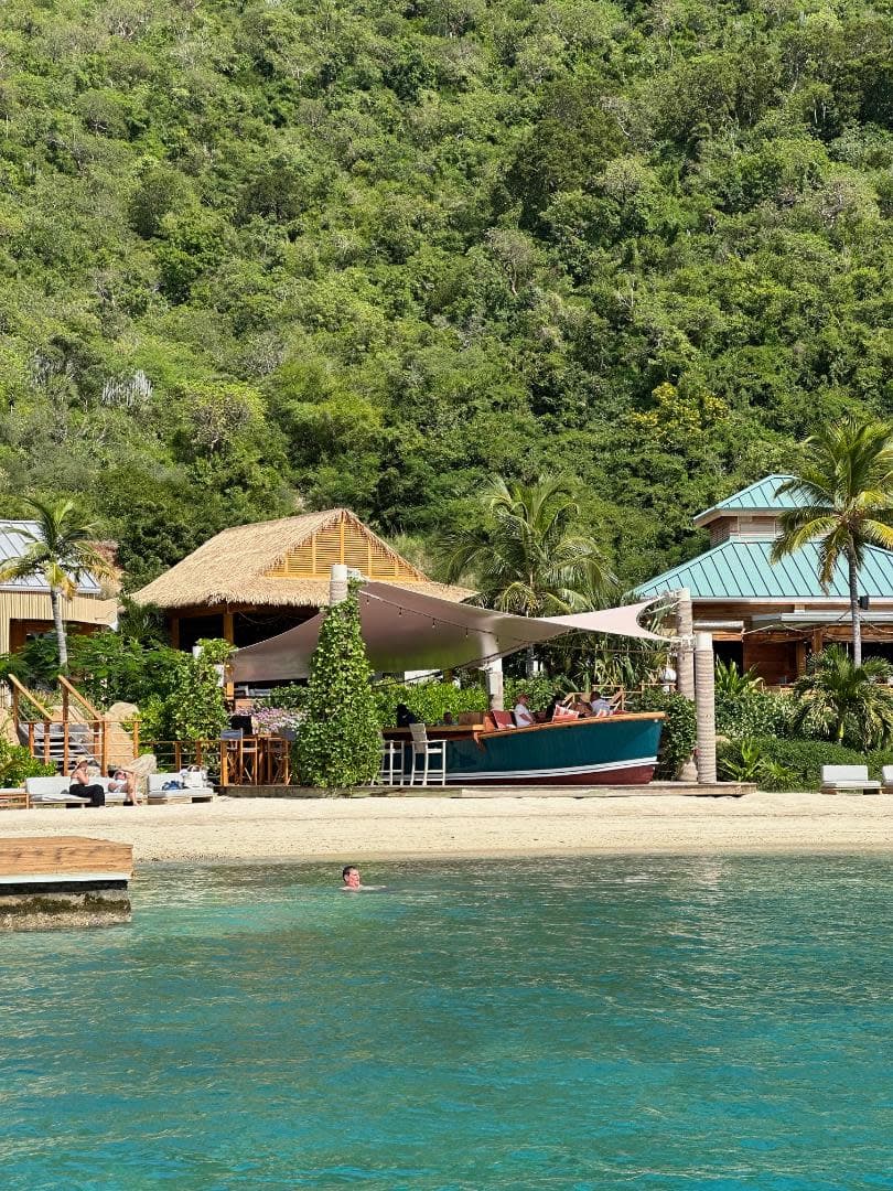 A yacht club on the beach in front of a forest