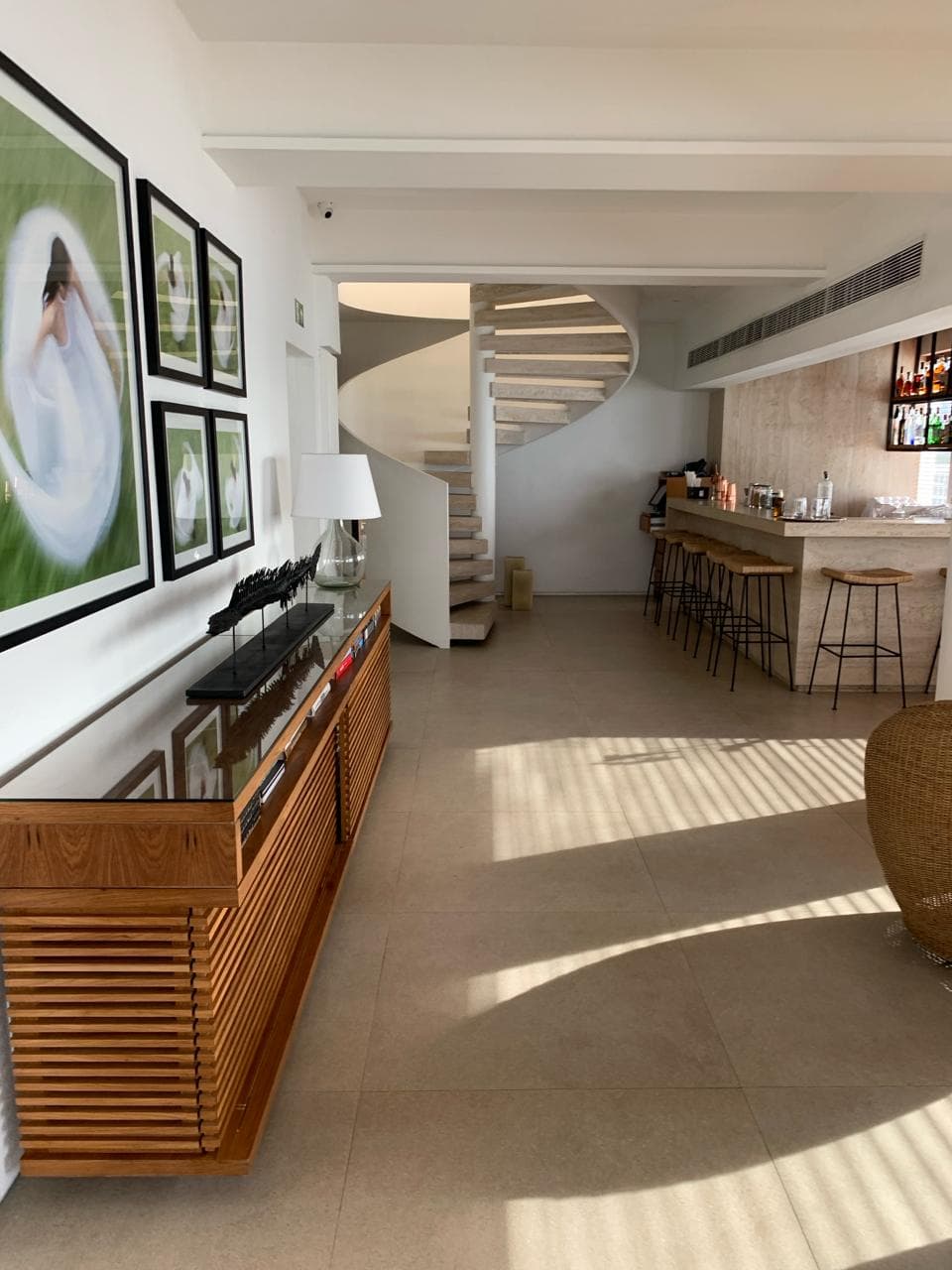 Modern and light hotel interior showing bar and paintings on wall