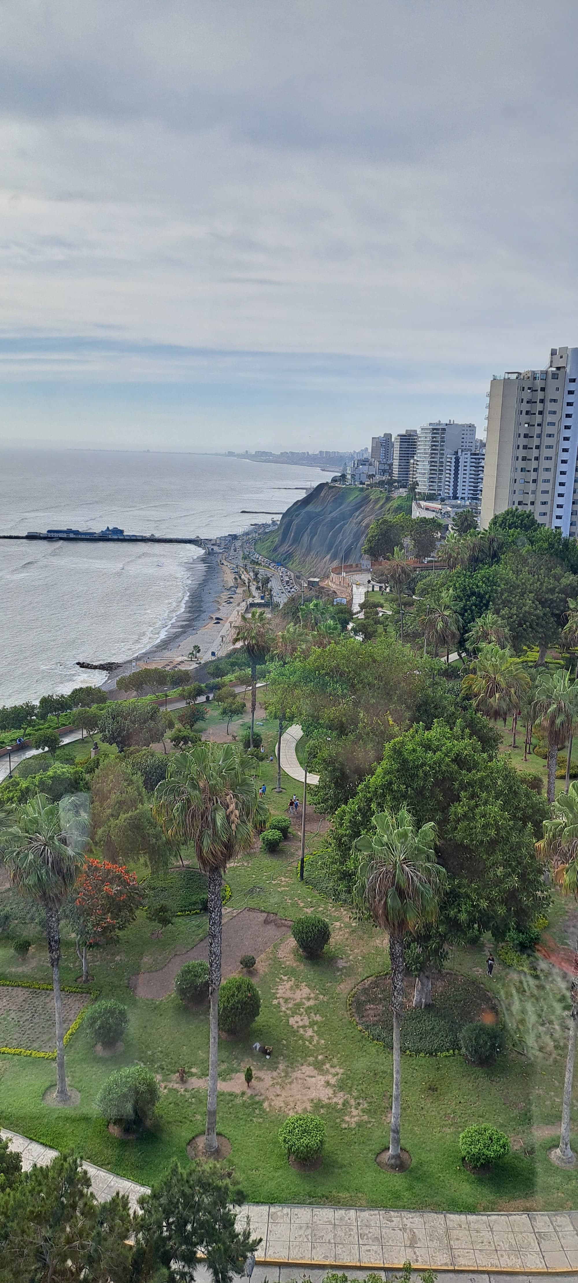 An above view of a city and coastline during a cloudy day