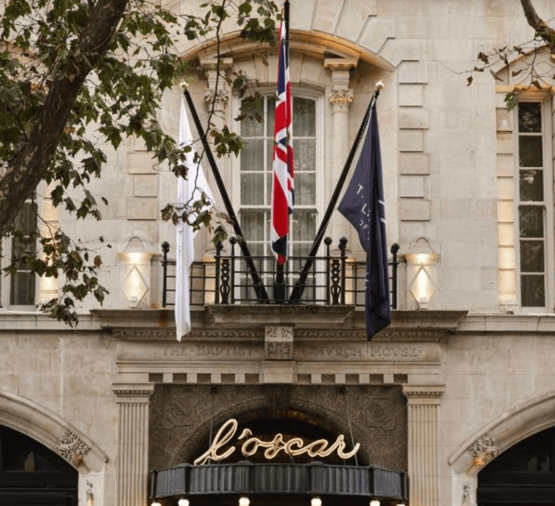 Hotel Exterior in London with the countries flags and upscale lighting.