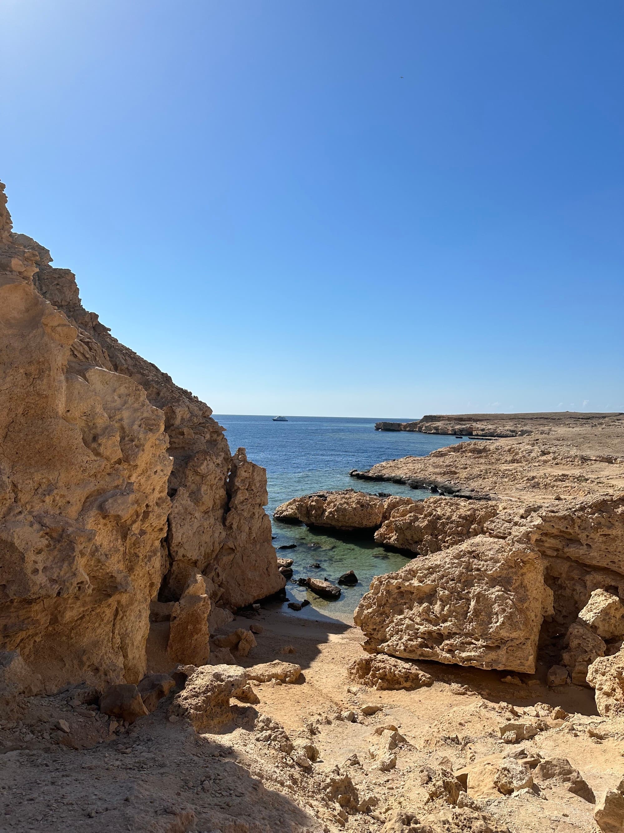 Desert-colored rock outcroppings by the ocean