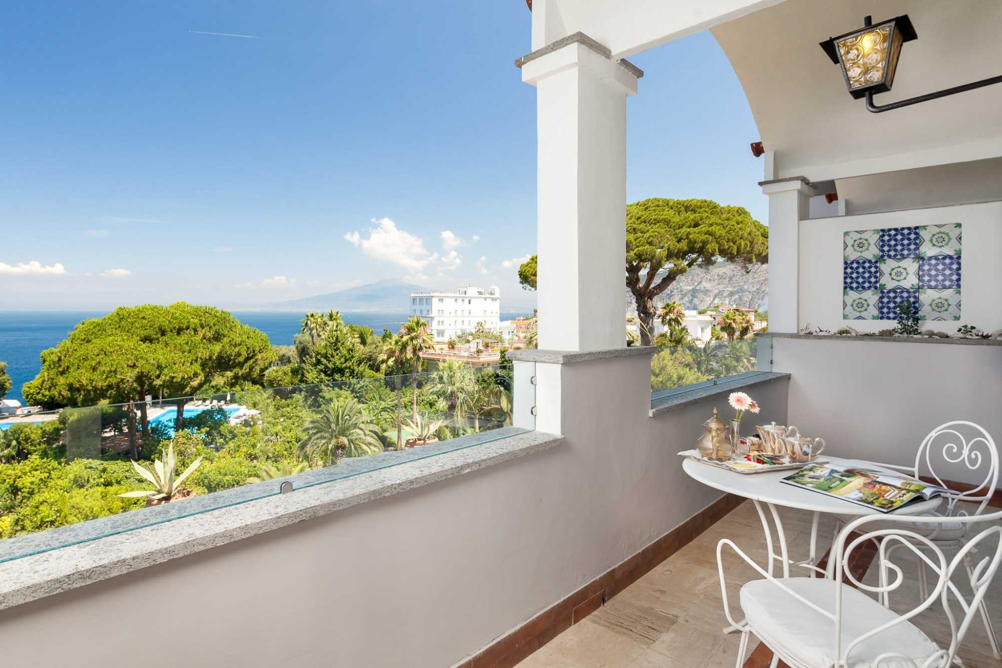 View of trees and the sea from a terrace during daytime