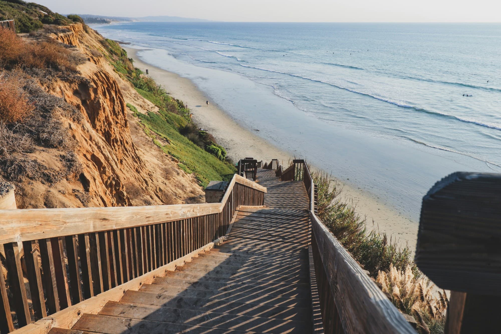 A set of wooden steps leading down to a beach