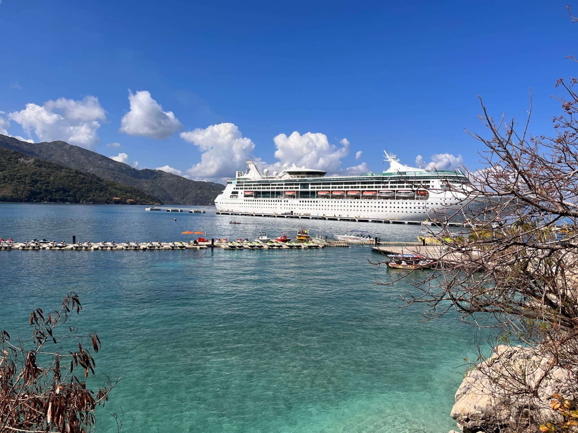 A photo of a cruise ship in the water taken from land